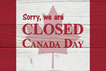 Closed Canada Day message with Canadian maple leaf flag on wood