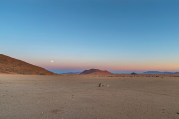 Moon rise as the sun set in Namib Desert