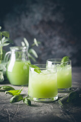 Cold basil lemonade refreshing summer drink on gray background