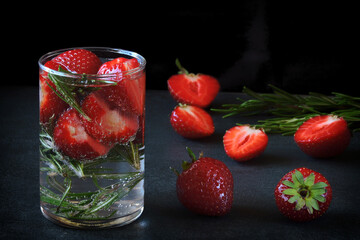 Refreshing mineral water drink with strawberries and rosemary. Detox drinks. Diet concept.