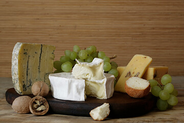 types of cheese on wooden board