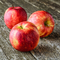 Green and red apples on blackboard or chalkboard background. Bright fruit composition.Red and green apple on old wooden table. Top view with space for your text