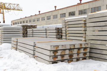 Reinforced concrete slabs intended for the construction of roads and airfields. Storage at the warehouse of the precast concrete plant.