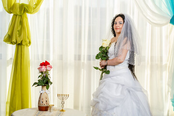 The Jewish bride is waiting for the groom before the chuppa ceremony.