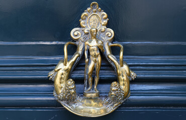 European Vintage old metal wrought iron door knocker. Design detail. Paris.