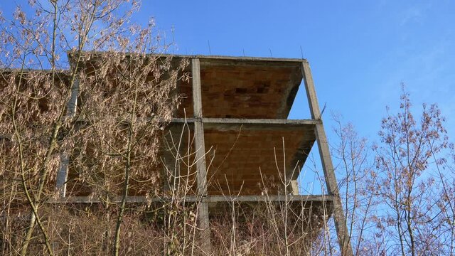 Incomplete structure of a house in the middle of nature. Contaminated Nature. Panning 4K