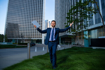 Success business. Amazed businessman stand up and urban city background.