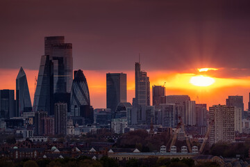 Fototapeta na wymiar The skyline of the City of London with the modern office skyscrapers shining in the red sunset light