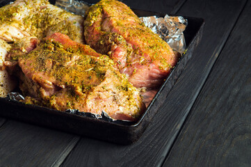 Raw meat veal and chicken legs on a baking sheet are prepared for baking in the oven. The national meat dish is prepared on the eve of the holidays. Free advertising space