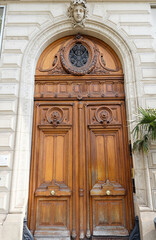 Old ornate door in Paris - typical old apartment buildiing.