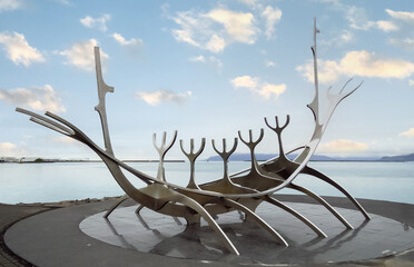 The Sun Voyager by Jón Gunnar Árnason, a large steel ship sculpture along the Reykjavik Sculpture and Shore Walk, Iceland - obrazy, fototapety, plakaty