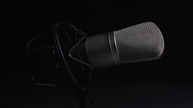 Professional studio microphone on an anti vibration stand, being side lit
