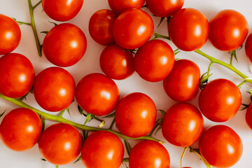 small red cherry tomatoes on white background. Red tomatoes for pasta or salad 