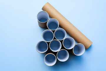 Empty toilet rolls on light blue background