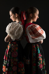 Young beautiful slovak women in traditional dress. Slovak folklore - obrazy, fototapety, plakaty