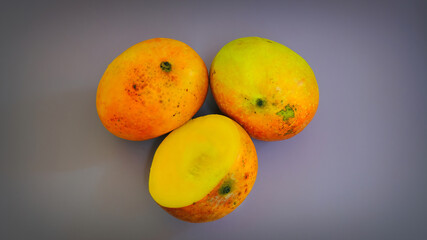Fresh ripe sliced and whole mango on dark background. Juicy fruits background. Healthy eating, Fruit juice shop. 