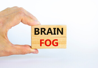 Medical and COVID-19 Pandemic Coronavirus brain fog symbol. Doctor holds wooden blocks with words...