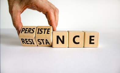 Persistence or resistance symbol. Businessman turns cubes, changes the word 'resistance' to...