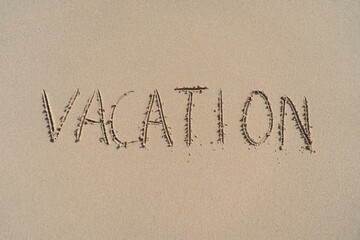 Vacation inscription on summer sandy beach. Leisure and adventure concept