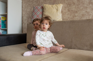 two little girls sitting on the couch