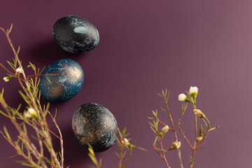 Dyed easter eggs with with beautiful flowers on a purple background. Pattern