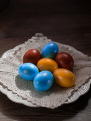 easter eggs and kulich on a plate on the background