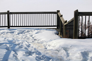 View of railing along a winter path