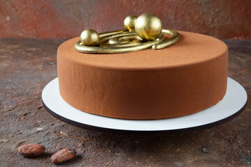 Traditional French mousse dessert - dark and milk chocolate cake with vanilla, cream, and beautiful decoration with cocoa beans on a cosmic background - side view and close-up