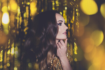 Attractive young model woman celebrity with makeup on golden bokeh background