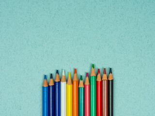 School conception, collorfull school pencils on a blue background. Back to school. Flatlay, top view, copy space.