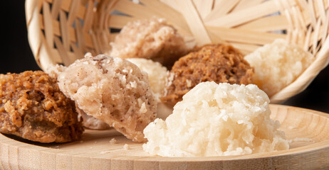 Cocada, Coconut candy from Brazil, white and brown cocadas on round wood fallen from a straw...