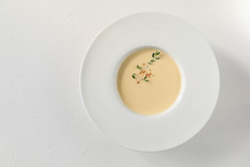 Traditional Italian egg soup ginestrata with spices - nutmeg, thyme, and cinnamon from Tuscany - top view with copy space