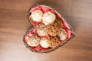 Cocada, Coconut candy from Brazil, white and brown heart-shaped wooden cocadas, top view.