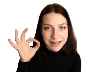 Orthodontic treatment. Dental care concept. Smiling teenage girl with braces. Metal braces close-up on the teeth.