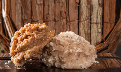 Cocada, Coconut candy from Brazil, white and brown cocadas in close up on a rustic wooden surface and background, selective focus.