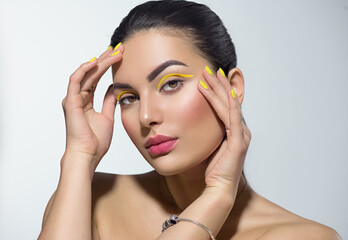 Beauty model girl with fashion make-up, Bright yellow eye line and nails, trendy manicure. Eye make-up creative ideas. Summer makeup. Beautiful young woman portrait. Face closeup - 431584203