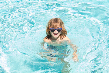 Kids summer vacation. Activities on pool. Having fun at aquapark. Kid swimming in water.