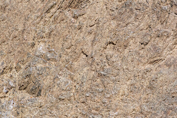 Brown, rustic, stone surface divided by splitting