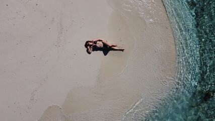 Mature lady on vacation laying on a tropical beach