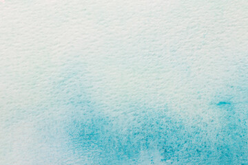 Abstract blue watercolor background. The color splashing on the paper. Hand drawn.