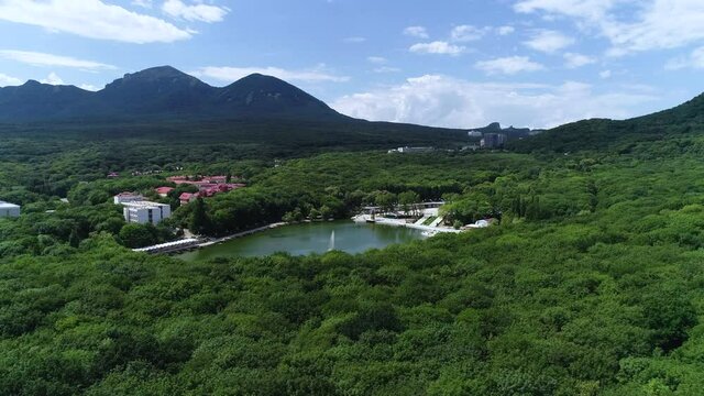 A small pond in the city, next to the mountain