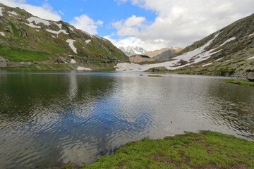 Naklejka na ściany i meble Alpine lake in the mountains Col du Grand Saint Bernard border Italy/Switzerland