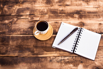 Obraz na płótnie Canvas coffee,calculator and notebook on wooden background