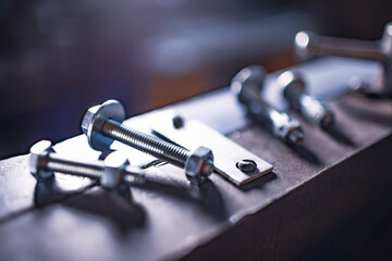 Metal chrome bolts and nuts on manual flexible massive machine