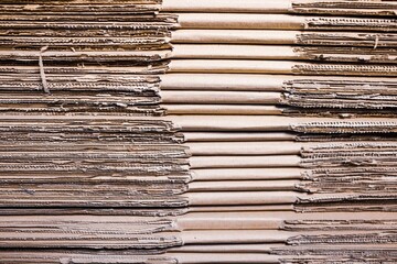 Close-up sides of stacks of cardboard folded