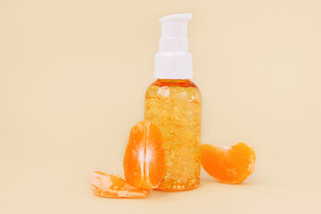 Glass transparent pump bottle with orange moisturizing serum. Packaging cosmetic product mockup