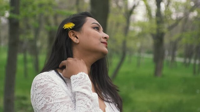 Portrait of a beautiful indian young woman with yellow dandelion 