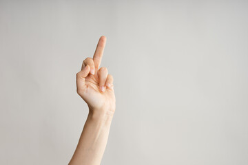 Hand gestures. Middle finger, aggressive gesture. Women's hand