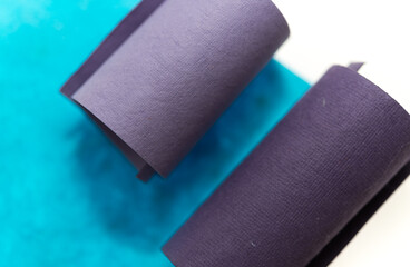 abstract composition of paper tubes swirls and folds on white