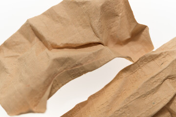 crumpled sand-brown patterned and textured paper isolated on a white background